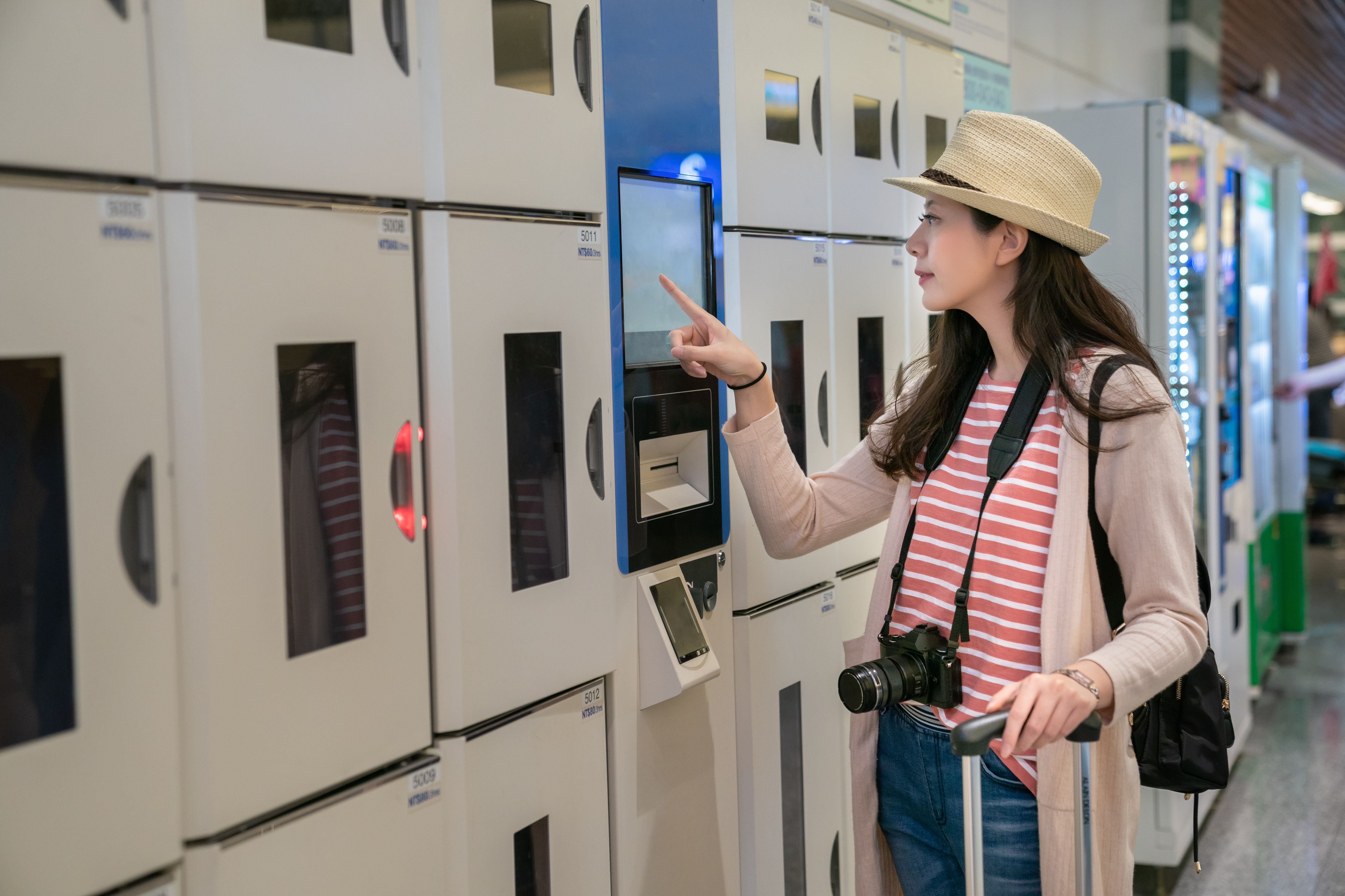 woman-confirming-intelligent-coin-lockers-trying-use-one-view-from-side.jpg